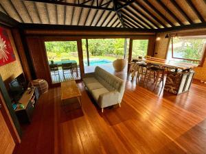 un soggiorno con un divano e un tavolo di VILLA TEPUA a aUturoa