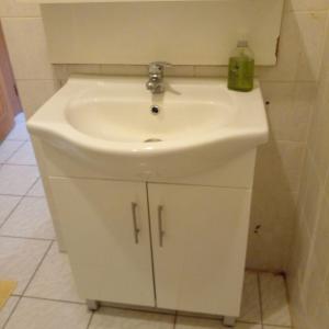 a white bathroom sink with a green bottle on it at Holidays in Martinique - Ravenala in Sainte-Anne