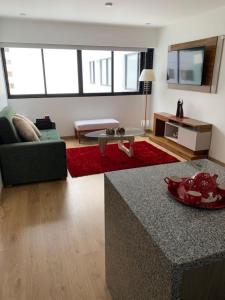 a living room with a couch and a table at 2BR in Center of Miraflores La Paz in Lima