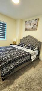 a bedroom with a large bed in a room at Cozy 3 bedroom townhouse in downtown Edmonton in Edmonton