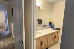 a bathroom with a sink and a mirror at Cozy 3 bedroom townhouse in downtown Edmonton in Edmonton