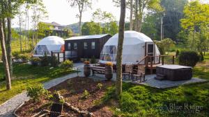 a couple of yurt tents in a yard at Luxury Glamping Geodome-Hot tub, Winery in Banner Elk