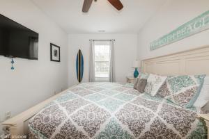 a bedroom with a bed and a flat screen tv at Comfy, Convenient Close to Rehoboth and Lewes! in Rehoboth Beach
