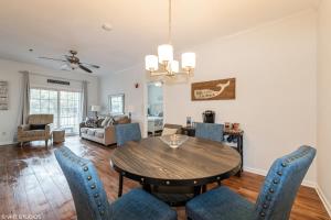 a dining room and living room with a table and chairs at Comfy, Convenient Close to Rehoboth and Lewes! in Rehoboth Beach