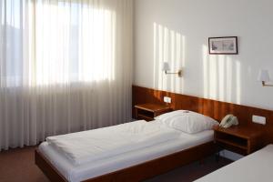 Postel nebo postele na pokoji v ubytování Hotel La Taverna