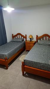 two beds sitting next to each other in a room at Sueños Del Pilar II in Godoy Cruz
