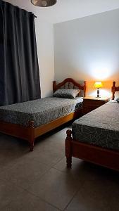 Una cama o camas en una habitación de Sueños Del Pilar II