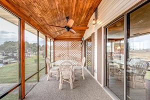 a screened in porch with a table and chairs at Beech Retreat in Inverness