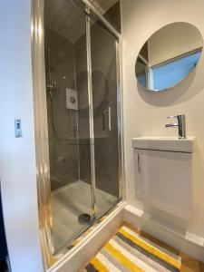 a bathroom with a shower and a sink at Penlea ~ 1 bedroom Flat with Harbour view in Tarbert +11 photos