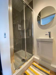 a bathroom with a shower and a sink at Penlea ~ 1 bedroom Flat with Harbour view in Tarbert