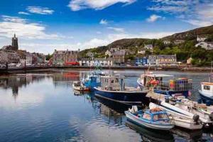 a group of boats are docked in a harbor at Penlea ~ 1 bedroom Flat with Harbour view in Tarbert