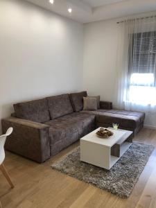 a living room with a couch and a coffee table at Apartment TAJM in Trebinje