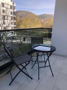 a table and chairs on a balcony with a view at Apartment TAJM in Trebinje