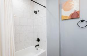 a white bathroom with a shower and a white tub at Cozy Cottage-Bourbon Trail, Expo, YUM, Derby! in Louisville