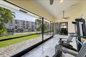 a balcony with two chairs and a view of a building at Marble House in Lauderdale Harbours in Fort Lauderdale