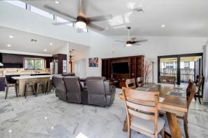 a dining room and living room with a table and chairs at Marble House in Lauderdale Harbours in Fort Lauderdale