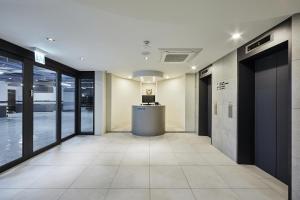 an office hallway with large windows and a reception desk at Hotel Intro in Busan