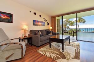 a living room with a couch and a table at Valley Isle 302 in Kahana
