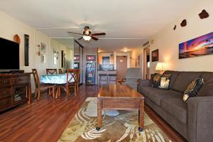 a living room with a couch and a table at Valley Isle 302 in Kahana