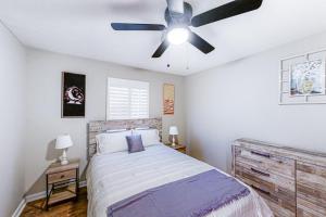 a bedroom with a bed with a ceiling fan at The Bird House 