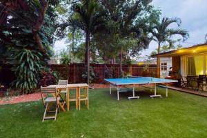a ping pong table and chairs in a yard at Walking On Sunshine - Studio in Fort Lauderdale