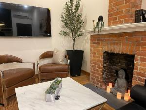 a living room with a couch and a fireplace at 3 Bedroom Victorian with Deck and Parking in Toronto