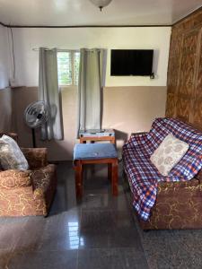 a living room with two couches and a tv at Panglao Vacation Home in Panglao Island