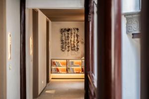 a hallway leading to a room with shelves at Zunjing Boutique Hotel Nanjing Confucius Temple in Nanjing