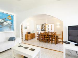 a living room with a white couch and a table at Casa L'Escala, 4 dormitorios, 8 personas - ES-325-12 in Torroella de Montgrí