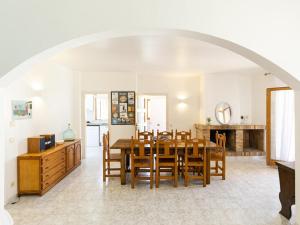 a kitchen and dining room with a table and chairs at Casa L'Escala, 4 dormitorios, 8 personas - ES-325-12 in Torroella de Montgrí