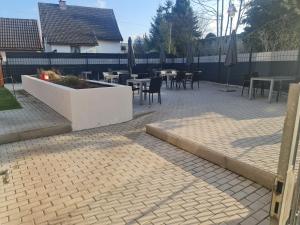 a patio with tables and chairs and umbrellas at Ferienwohnung Dippoldiswalde in Dippoldiswalde