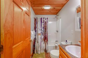 a bathroom with a toilet and a sink and a shower at Loafinit in Carrabassett
