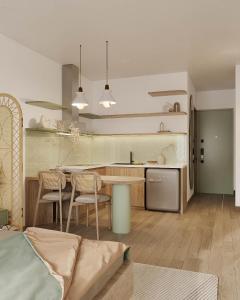 a kitchen and living room with a table and chairs at The Urban Westlake Apartment in Hanoi