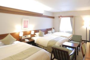 Postel nebo postele na pokoji v ubytování Kurashiki Kokusai Hotel