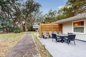 a patio with a table and chairs next to a house at 4628 Whimbrel Lane in Fernandina Beach