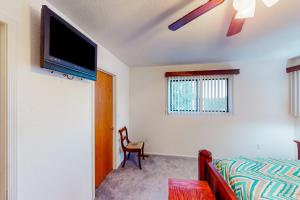 une chambre avec un lit et une télévision au mur dans l'établissement Stunning Skyline, à Show Low