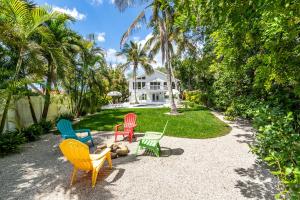 a group of chairs sitting in front of a house at Luxury getaway steps from beach sleeps 10 in Siesta Key