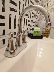 a sink with a faucet and two cups on it at Home Near Downtown Norfolk in Norfolk