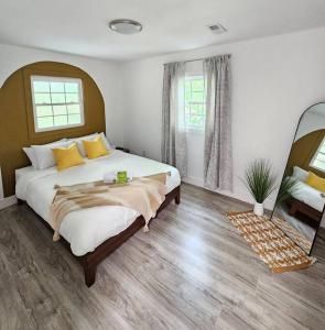 a bedroom with a large bed with yellow pillows at Home Near Downtown Norfolk in Norfolk