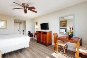 a bedroom with a bed and a desk and a television at Bayside at Sandestin #6769 in Destin
