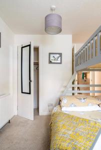 Tullibody的住宿－Ochil View Holiday Let，一间卧室设有双层床和楼梯。