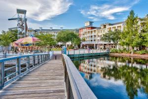 a wooden walkway next to a river with buildings at Bayside at Sandestin #6769 in Destin