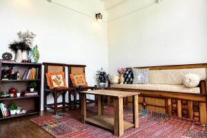 a living room with a couch and a table at Mohija Homestay in Kandāghāt