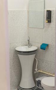 a bathroom with a toilet and a sink at Mohija Homestay in Kandāghāt +200 photos