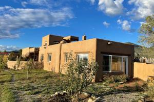 a house in the middle of a yard at Sunset Studio in Taos