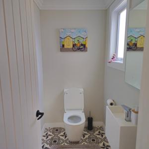 a bathroom with a white toilet in a room at Che Bella in Martinborough