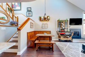 a living room with a table and a staircase at Oaks Paradise in Galena