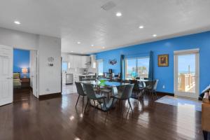 a kitchen and dining room with a table and chairs at Immaculate, modern stay steps to beach with amazing ocean views in Painters Hill