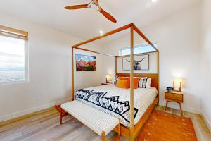 1 dormitorio con cama con dosel y ventilador de techo en Modern Mountain Escape, en Cedar City