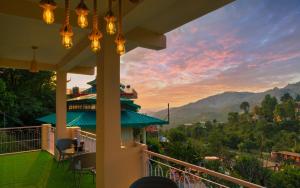 a balcony of a house with a view of the mountains at Mohija Homestay in Kandāghāt